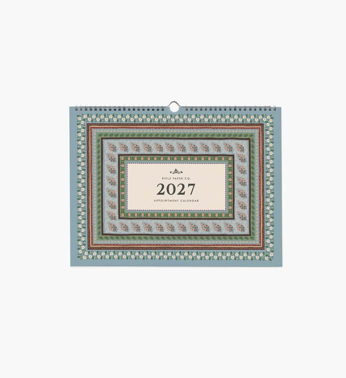 A 2027 wall calendar with a sage green background, white floral pattern, and a dark burgundy central label, shown against a plain white background.