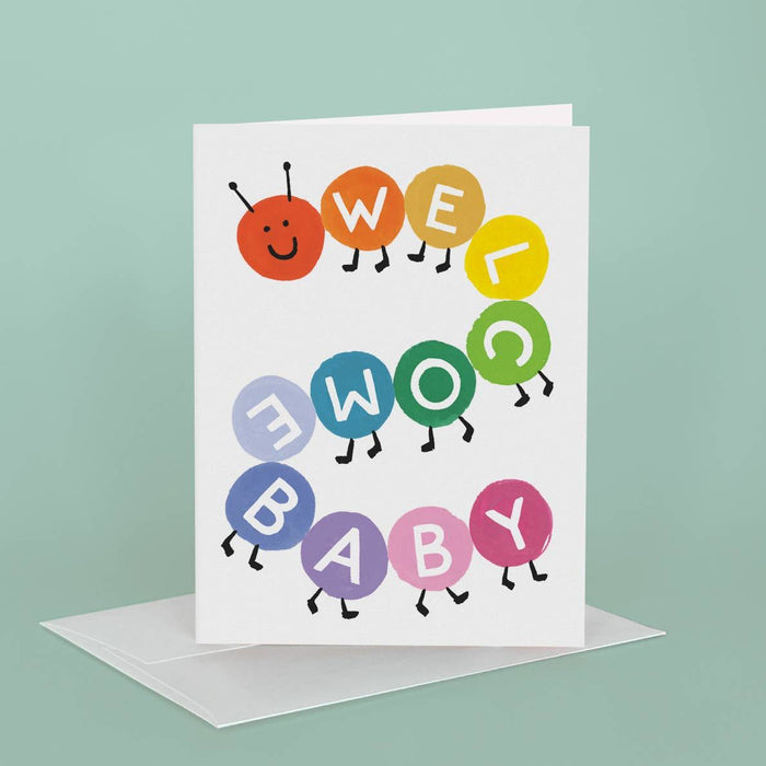 Greeting card with colorful letters spelling 'Well Done Baby' on a light green background