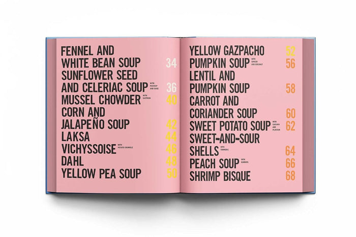 An open book or menu spread with a pink page listing soup names and numbers, photographed against a clean white background.