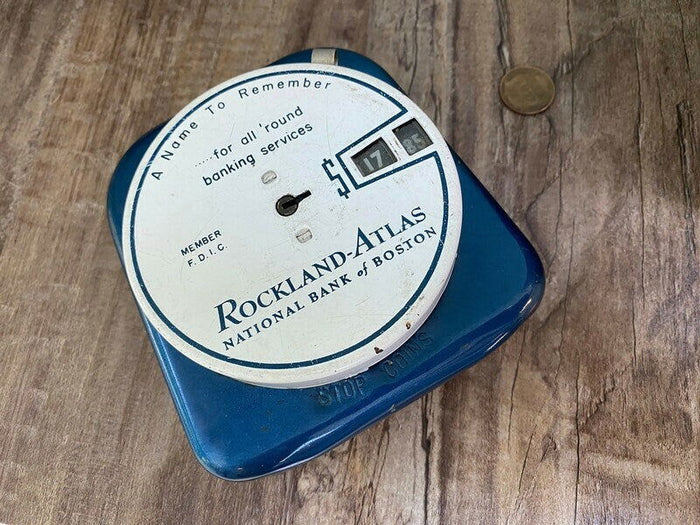 RL. Midcentury Advertising Add a Coin Bank at Duckwells