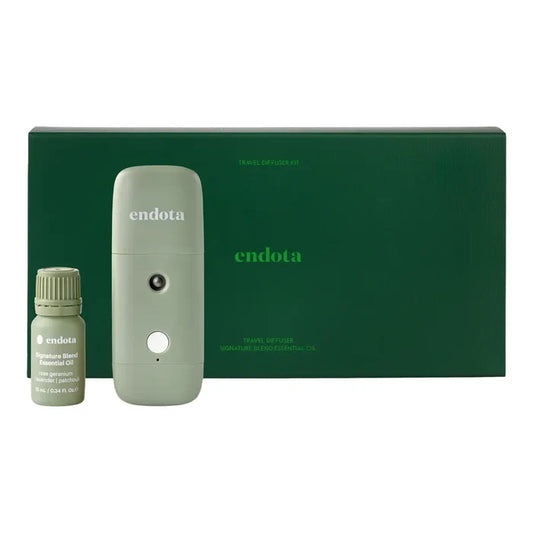 Endota Travel Diffuser Kit featuring a sage green portable diffuser, a small bottle of essential oil, and a dark green presentation box on a white background.
